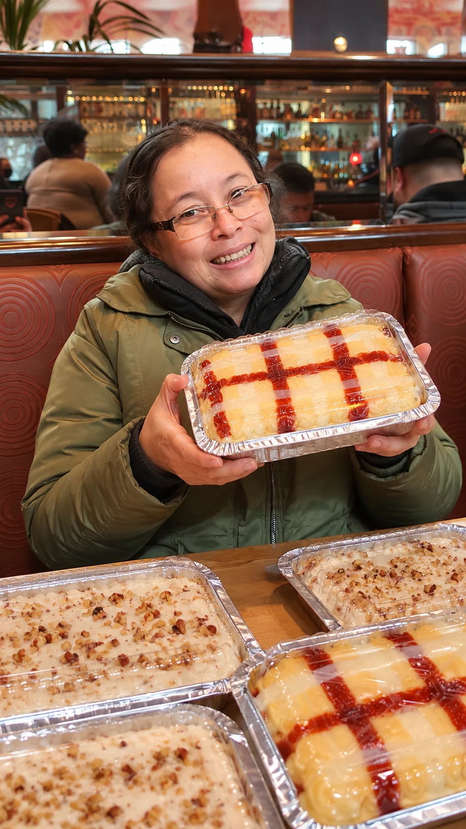 Johanna smiling and holding desserts at the table